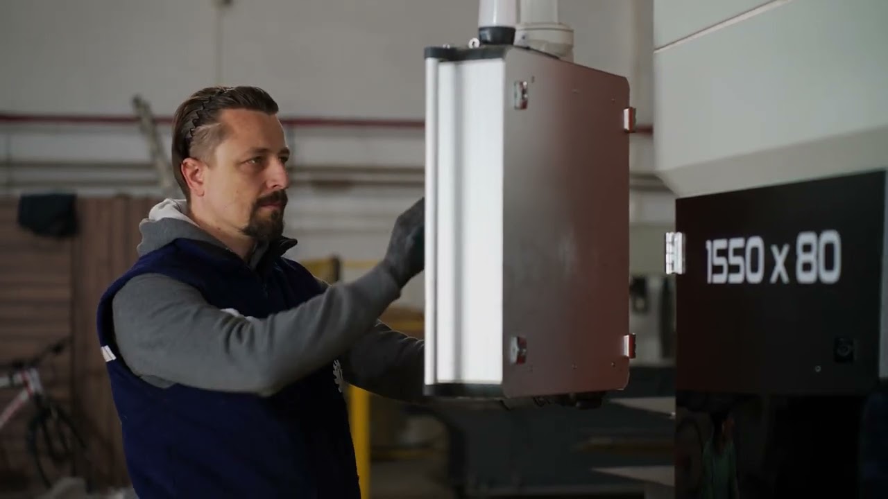 operator using control panel on leveling machine